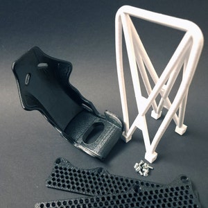 Transform your workspace with this incredible customizable DIY racing seat phone holder kit. It features an unassembled roll cage design that allows you to create a unique and stylish phone stand for your desk. Elevate your workspace today! Nine3D