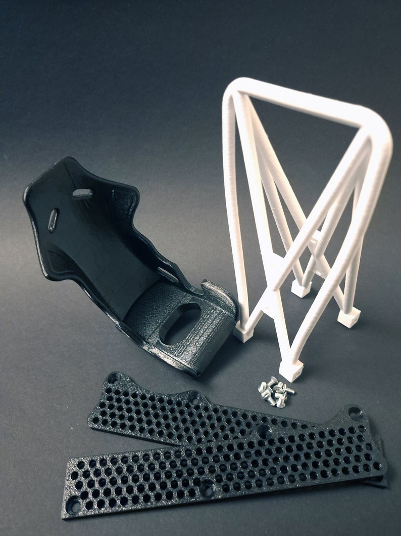Transform your workspace with this incredible customizable DIY racing seat phone holder kit. It features an unassembled roll cage design that allows you to create a unique and stylish phone stand for your desk. Elevate your workspace today! Nine3D