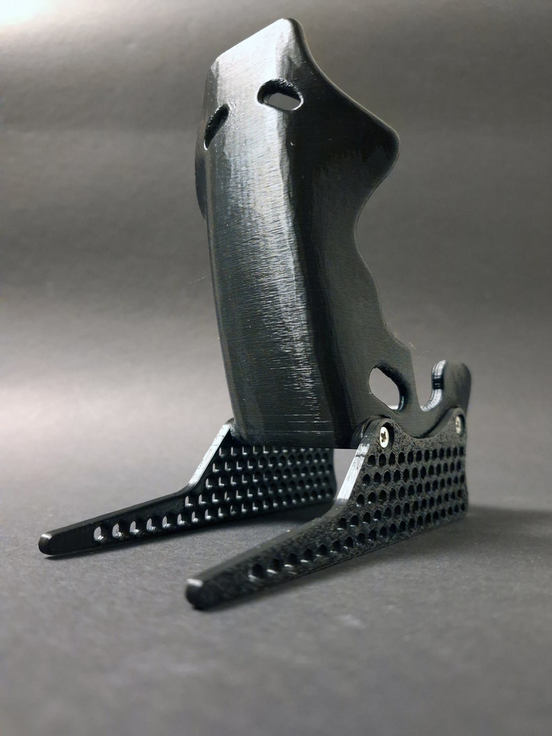 Discover the perfect blend of functionality and style with our racing seat phone holder. Ideal for motorsport enthusiasts, this 3D-printed accessory will change Your desk design and decor. Explore Nine3D shop's unique 3D-printed collection