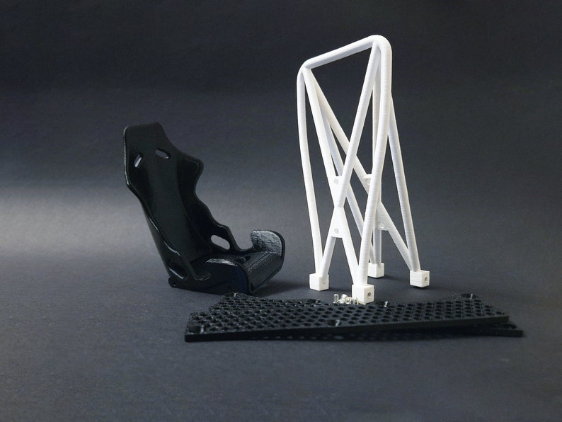 Transform your workspace with this incredible customizable DIY racing seat phone holder kit. It features an unassembled roll cage design that allows you to create a unique and stylish phone stand for your desk. Elevate your workspace today! Nine3D