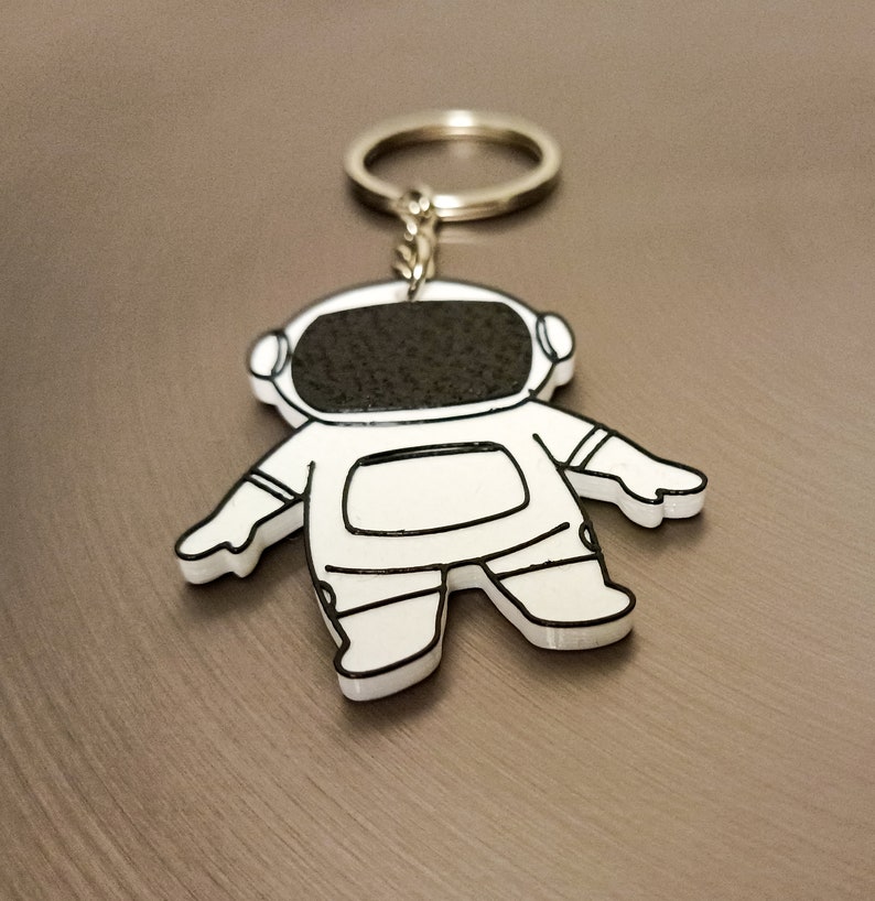 Explore our 3D printed spaceman astronaut keychain, a must-have accessory for space enthusiasts. Elevate your style with this unique cosmic gift. Ideal for gifting or personal use, it's a perfect blend of artistry and functionality. Shop Nine3D