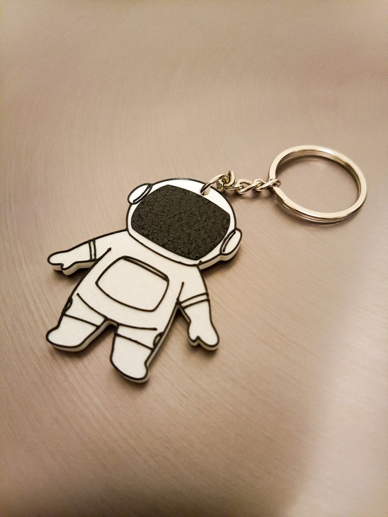 Explore our 3D printed spaceman astronaut keychain, a must-have accessory for space enthusiasts. Elevate your style with this unique cosmic gift. Ideal for gifting or personal use, it's a perfect blend of artistry and functionality. Shop Nine3D