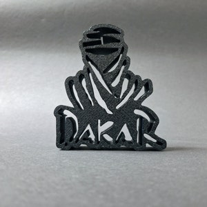 3D printed DAKAR logo stand in black, front perspective