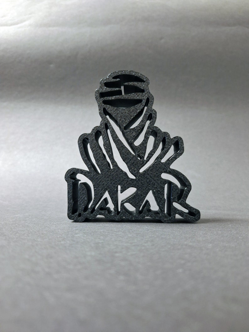 3D printed DAKAR logo stand in black, front perspective