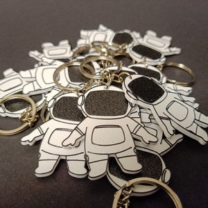 Explore our 3D printed spaceman astronaut keychain, a must-have accessory for space enthusiasts. Elevate your style with this unique cosmic gift. Ideal for gifting or personal use, it's a perfect blend of artistry and functionality. Shop Nine3D