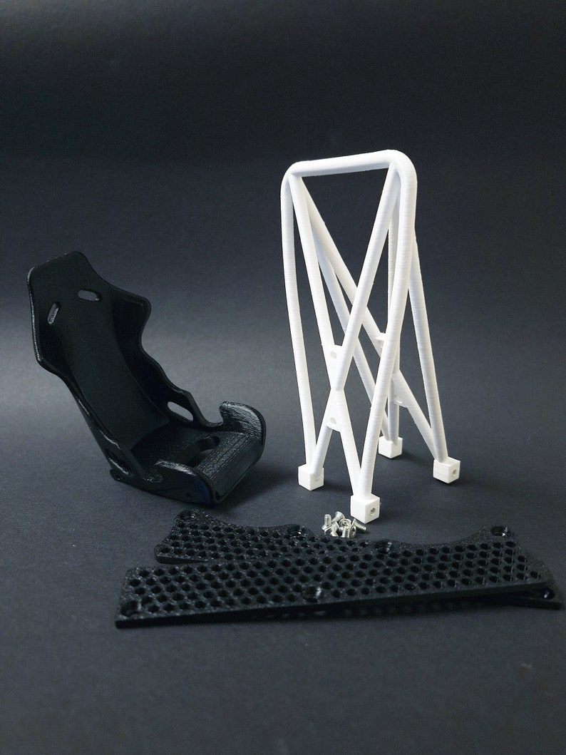 Transform your workspace with this incredible customizable DIY racing seat phone holder kit. It features an unassembled roll cage design that allows you to create a unique and stylish phone stand for your desk. Elevate your workspace today! Nine3D