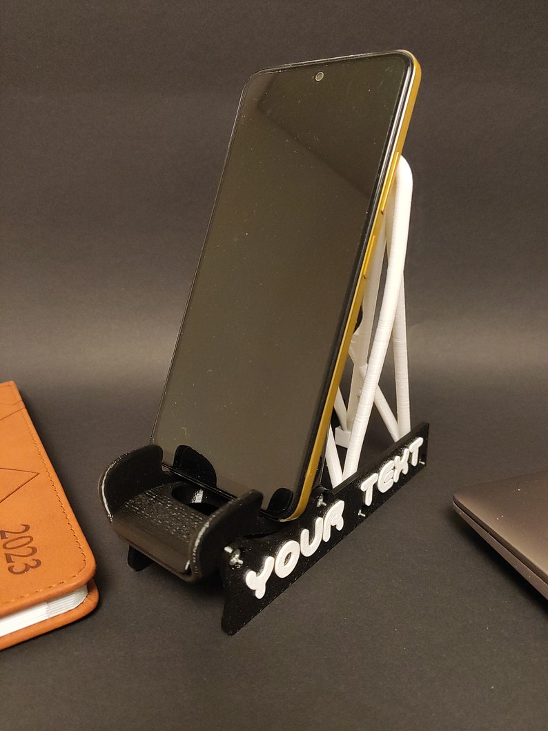 Discover the perfect blend of functionality and style with our racing seat phone holder. Ideal for motorsport enthusiasts, this 3D-printed accessory will change Your desk design and decor. Explore Nine3D shop's unique 3D-printed collection