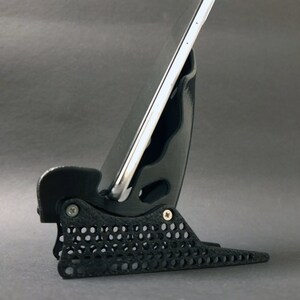 Discover the perfect blend of functionality and style with our racing seat phone holder. Ideal for motorsport enthusiasts, this 3D-printed accessory will change Your desk design and decor. Explore Nine3D shop's unique 3D-printed collection