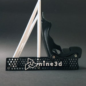 Discover the perfect blend of functionality and style with our racing seat phone holder. Ideal for motorsport enthusiasts, this 3D-printed accessory will change Your desk design and decor. Explore Nine3D shop's unique 3D-printed collection