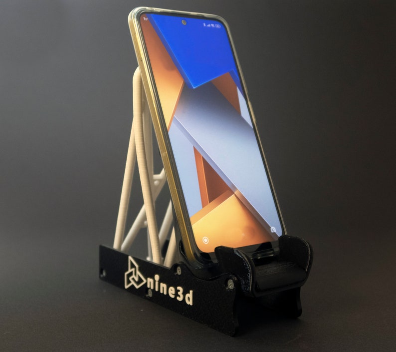 Discover the perfect blend of functionality and style with our racing seat phone holder. Ideal for motorsport enthusiasts, this 3D-printed accessory will change Your desk design and decor. Explore Nine3D shop's unique 3D-printed collection