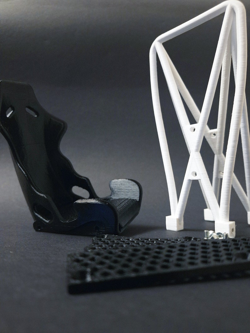 Transform your workspace with this incredible customizable DIY racing seat phone holder kit. It features an unassembled roll cage design that allows you to create a unique and stylish phone stand for your desk. Elevate your workspace today! Nine3D