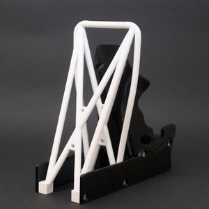 Discover the perfect blend of functionality and style with our racing seat phone holder. Ideal for motorsport enthusiasts, this 3D-printed accessory will change Your desk design and decor. Explore Nine3D shop's unique 3D-printed collection