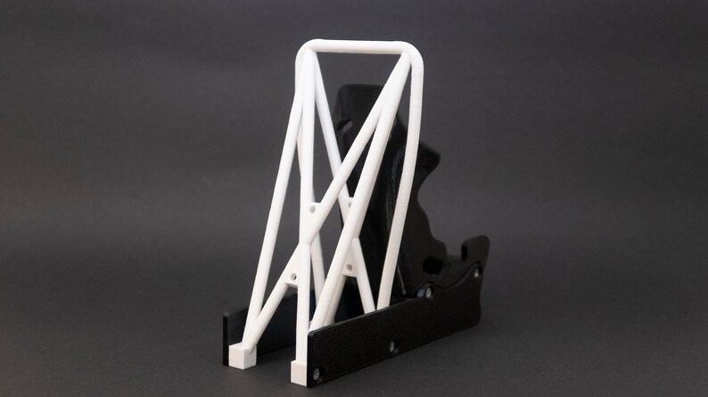 Discover the perfect blend of functionality and style with our racing seat phone holder. Ideal for motorsport enthusiasts, this 3D-printed accessory will change Your desk design and decor. Explore Nine3D shop's unique 3D-printed collection