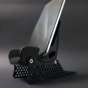 Discover the perfect blend of functionality and style with our racing seat phone holder. Ideal for motorsport enthusiasts, this 3D-printed accessory will change Your desk design and decor. Explore Nine3D shop's unique 3D-printed collection