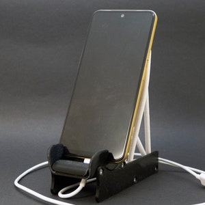 Discover the perfect blend of functionality and style with our racing seat phone holder. Ideal for motorsport enthusiasts, this 3D-printed accessory will change Your desk design and decor. Explore Nine3D shop's unique 3D-printed collection