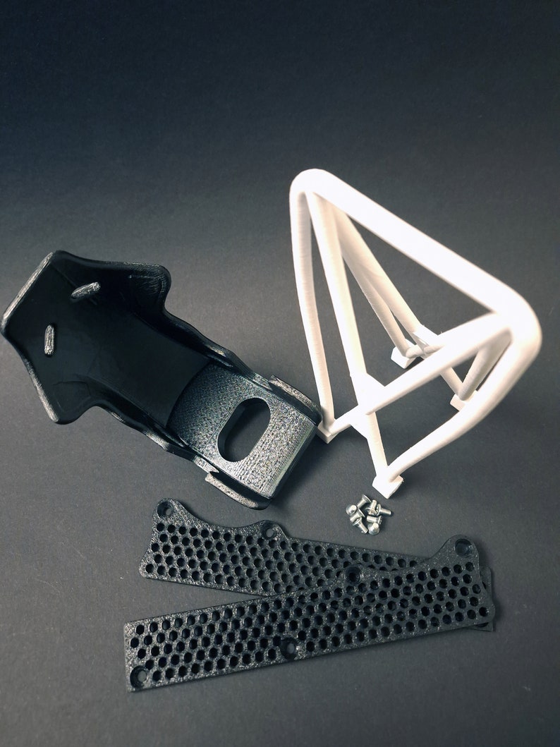 Transform your workspace with this incredible customizable DIY racing seat phone holder kit. It features an unassembled roll cage design that allows you to create a unique and stylish phone stand for your desk. Elevate your workspace today! Nine3D