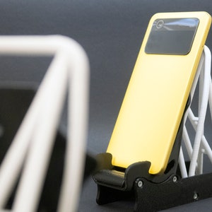 Discover the perfect blend of functionality and style with our racing seat phone holder. Ideal for motorsport enthusiasts, this 3D-printed accessory will change Your desk design and decor. Explore Nine3D shop's unique 3D-printed collection