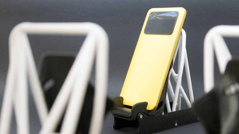 Discover the perfect blend of functionality and style with our racing seat phone holder. Ideal for motorsport enthusiasts, this 3D-printed accessory will change Your desk design and decor. Explore Nine3D shop's unique 3D-printed collection