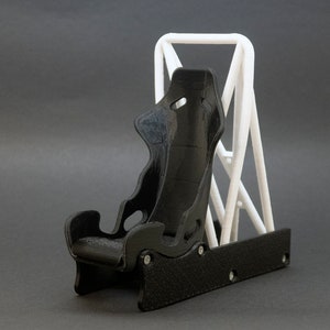 Discover the perfect blend of functionality and style with our racing seat phone holder. Ideal for motorsport enthusiasts, this 3D-printed accessory will change Your desk design and decor. Explore Nine3D shop's unique 3D-printed collection