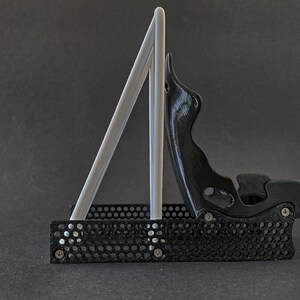 Discover the perfect blend of functionality and style with our racing seat phone holder. Ideal for motorsport enthusiasts, this 3D-printed accessory will change Your desk design and decor. Explore Nine3D shop's unique 3D-printed collection