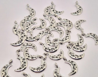 May include: Silver-toned crescent moon charms with star cutouts. These celestial-themed charms are ideal for jewelry making or other craft projects. The charms are small, measuring approximately 1 inch in length.