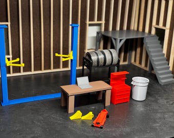 May include: A miniature garage workshop playset featuring a blue car lift, a red toolbox, a grey workbench, a laptop, a grey bin, and two yellow tyre ramps.