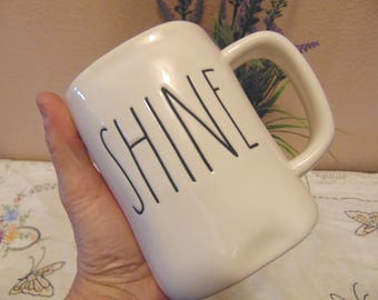 Darling pre owned Rae Dunn Coffee Mug " Shine" with yellow interior.