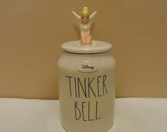 Brand New Never Used Rae Dunn Disney Tinkerbell Jar with sealed lid.