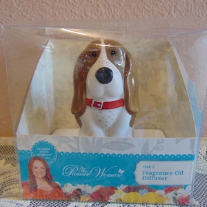 May include: A ceramic basset hound figurine fragrance oil diffuser named Charlie, featuring brown and white coloring with a red collar, packaged in a clear plastic box with The Pioneer Woman branding and floral graphics on the base.