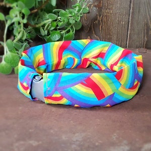 Rainbow print dog collar cover. Easily slips over existing collar. Machine washable. Protects from dirt. Smooth fit scrunch free collar wrap