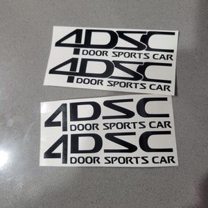May include: Four black vinyl stickers with the text "4DSC DOOR SPORTS CAR" repeated twice.