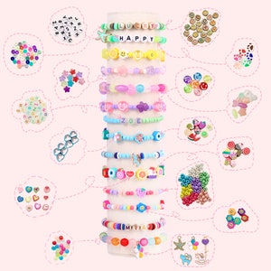May include: A stack of colorful bracelets with various charms and beads, including letters, smiley faces, flowers, and fruit. The bracelets are displayed on a white stand. The image also includes a variety of loose beads and charms.