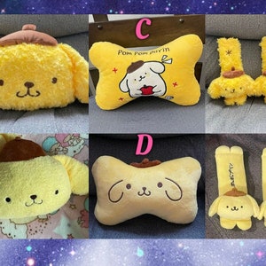 May include: A set of 10 plush Pom Pom Purin characters. The set includes a yellow and brown pillow, a yellow and brown neck pillow, and two pairs of yellow and brown headrest pillows. The pillows feature the Pom Pom Purin character with a brown hat and a red bow tie. The headrest pillows have the text "Pom Pom Purin" on them.