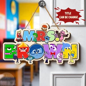 May include: Wooden door sign with the text "MRS. BROWN!" in colorful letters, featuring cartoon characters. The sign is suspended by a brown rope and is hanging on a white door. The text "TITLE CAN BE CHANGE" is also visible.