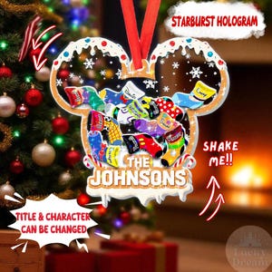 May include: A personalized Christmas ornament in the shape of Mickey Mouse ears, with the text "The Johnsons" at the bottom. The ornament is filled with colorful socks, each bearing a name. The text "Starburst Hologram", "Shake Me!!", and "Title & Character Can Be Changed" are also visible.