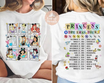 May include: White sweatshirt featuring a graphic of Disney princesses arranged in a grid. The back of the sweatshirt displays the text "Princess The Eras Tour" along with a list of princesses and their release dates.