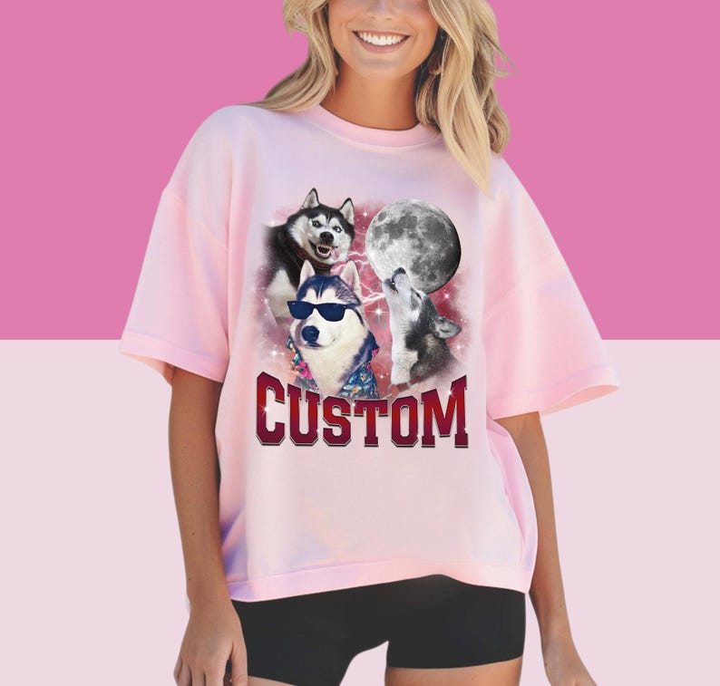 May include: Pink t-shirt with a graphic of three husky dogs howling at the moon. The text "CUSTOM" is printed below the image.
