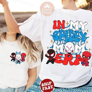 May include: Two white t-shirts with a graphic design featuring a spider-man theme. The design includes the text "In My Spidey Mom Era" with cartoon images of Spider-Man characters.