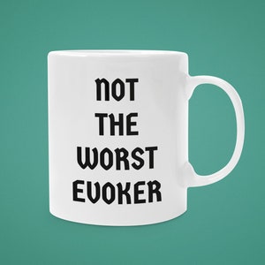 May include: White ceramic mug with black text that reads "not the worst evoker".