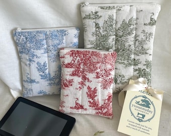 May include: Three toile patterned zippered pouches in blue, red, and green. The pouches are made of fabric and have a quilted texture. A small tag with the text "yusunnyday HANDMADE Custom-made just for you, wrapped with warmth and a touch of sunshine." is in the lower right corner of the image.