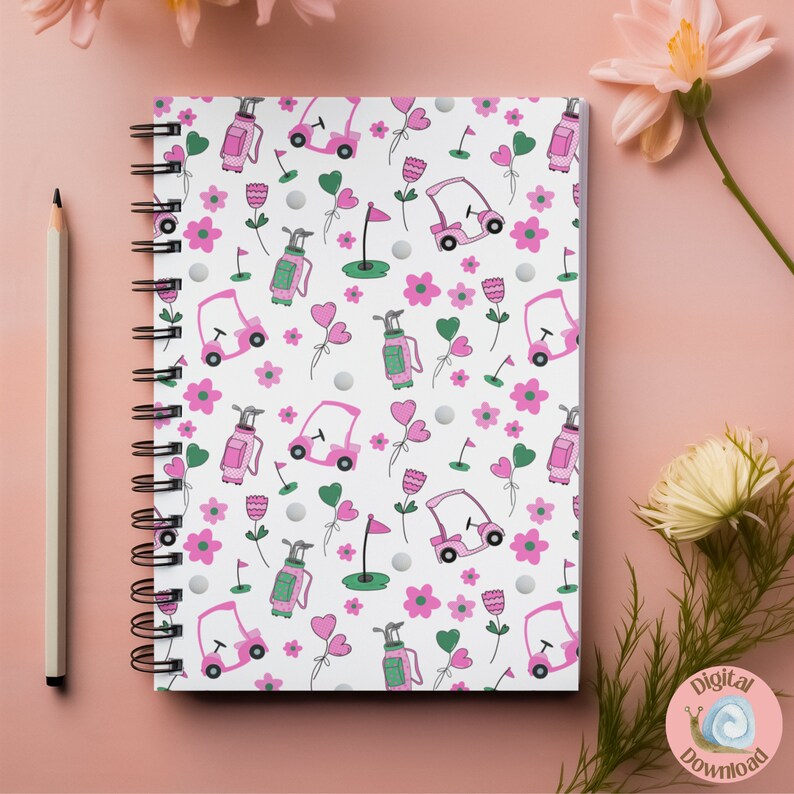 May include: A white notebook with a pink and green golf-themed pattern. The pattern includes golf carts, golf bags, golf balls, flowers, and hearts.