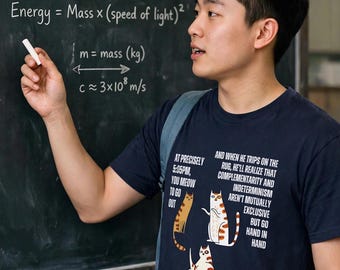 May include: A navy blue t-shirt featuring three illustrated cats and white text that reads: At precisely 5:05pm, you meow to go out. And when he trips on the rug, he'll realize that complementarity and indeterminism aren't mutually exclusive but go hand in hand. Sshhhh, somebody's coming.