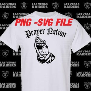 May include: White t-shirt with the text "Prayer Nation" in a gothic font, and a graphic of praying hands. The shirt also has the text "PNG - SVG FILE" in red. The Las Vegas Raiders logo is printed around the shirt.
