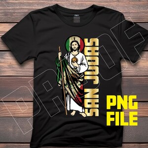 May include: Black t-shirt with a graphic of a man in a green, white, and red robe holding a staff. The text "San Judas" is written vertically in gold letters on the right side of the graphic.