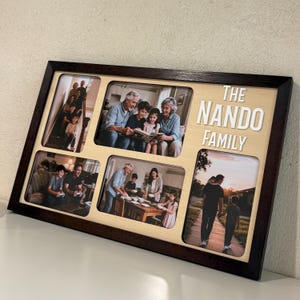 May include: A wooden family photo frame with six rectangular openings. The frame is dark brown, and the background is light beige. The text "THE NANDO FAMILY" is in white, raised letters. The openings contain family photos.