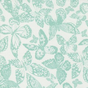 May include: A white fabric with a repeating pattern of light blue butterflies. The butterflies are stylised and have intricate wing details.
