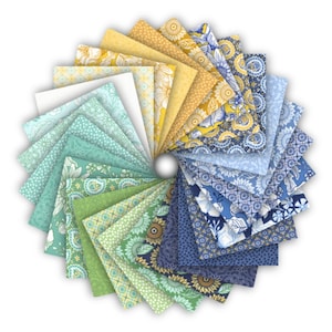 May include: A circular display of fabric squares in shades of blue, green, yellow, and white. The fabrics showcase floral and geometric patterns, creating a vibrant and colourful arrangement. Ideal for quilting or other fabric crafts.