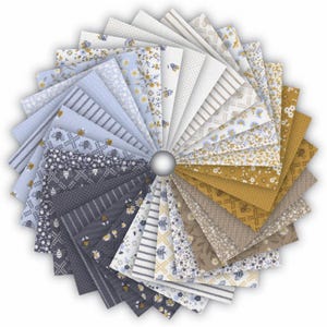May include: A circular display of fabric swatches in a range of patterns and colours. The fabrics showcase floral, striped, and dotted designs in shades of blue, yellow, grey, and white. The swatches are arranged around a central silver sphere, creating a fan-like arrangement.