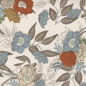 May include: A white fabric with a floral pattern. The flowers are blue, red, and beige. The leaves are brown.