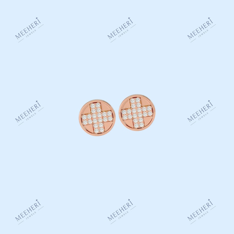 May include: A pair of rose gold stud earrings with a cross design set with small diamonds.